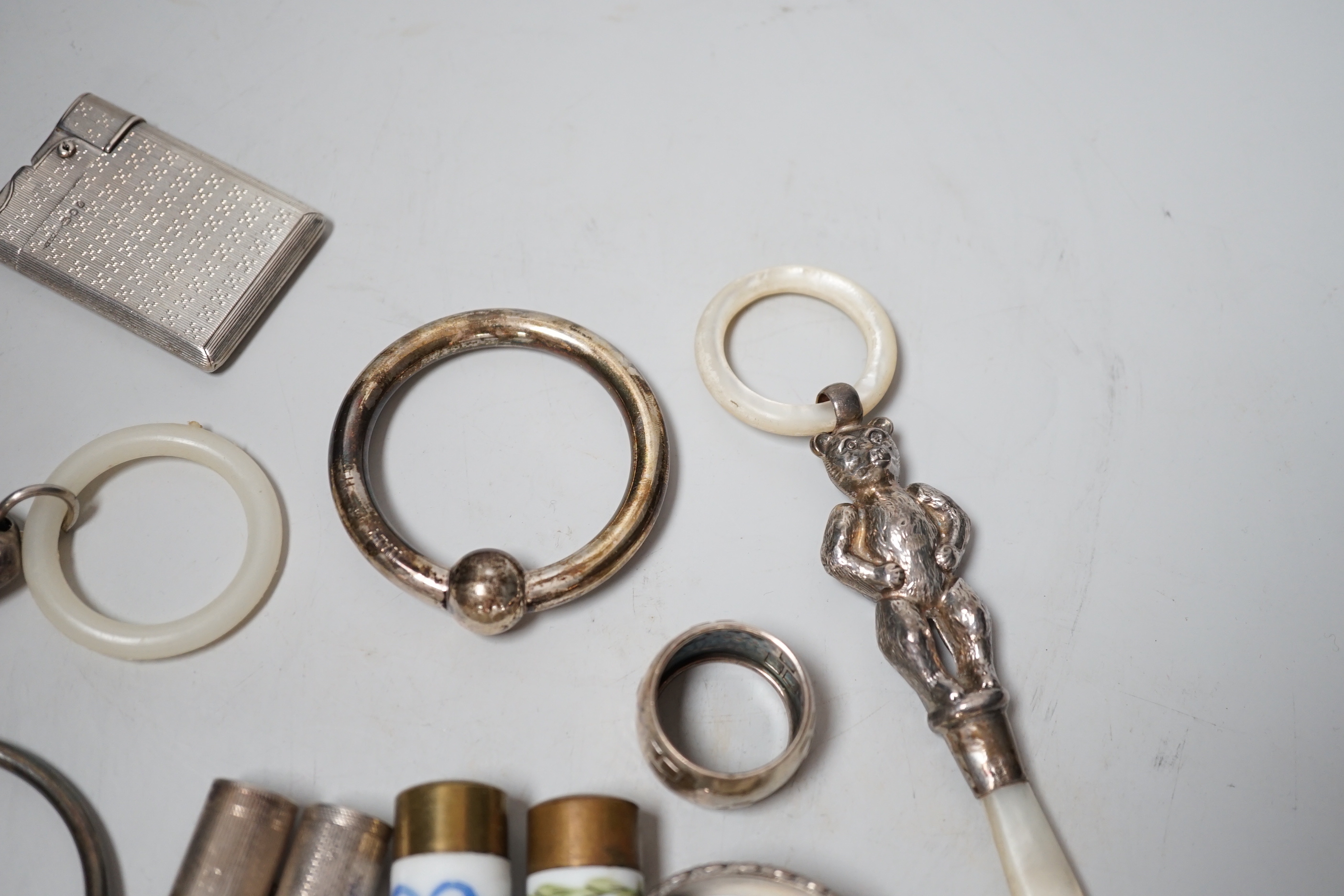 Sundry small silver and other items including teethers, rattles, Asprey & Co silver mounted lighter, etc.